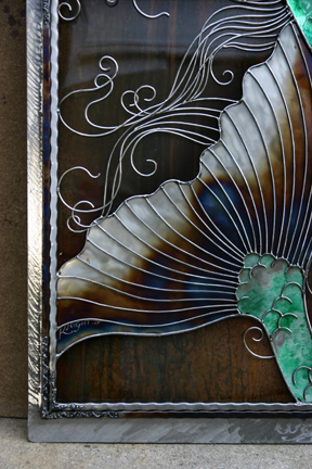 A look at a portion of the fin and hair against the marbled patina metal. 